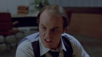 Movie still from “Scanners” (1981), directed by David Cronenberg – A person wearing a shirt and tie; Close Up shot, Low angle