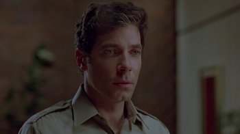 Movie still from “Scanners” (1981), directed by David Cronenberg – A man that is looking at the camera; Close Up shot, Over the shoulder angle