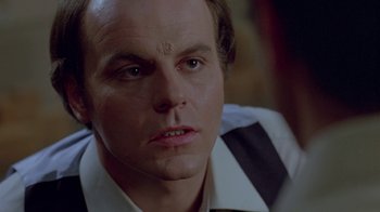 Movie still from “Scanners” (1981), directed by David Cronenberg – A person wearing a shirt and tie; Close Up shot, Over the shoulder angle