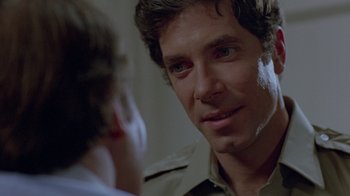 Movie still from “Scanners” (1981), directed by David Cronenberg – A person talking to another person; Close Up shot, Over the shoulder angle