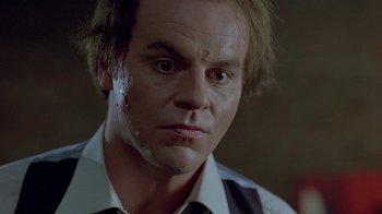 Movie still from “Scanners” (1981), directed by David Cronenberg – A person wearing a shirt and tie; Close Up shot, Low angle