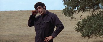 Movie still from “Scarecrow” (1973), directed by Jerry Schatzberg – A man standing in the middle of a dry field; Medium shot, Low angle