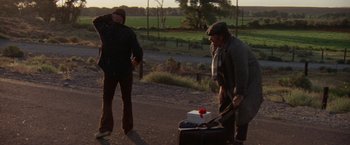 Movie still from “Scarecrow” (1973), directed by Jerry Schatzberg – Two men standing next to a suitcase on the side of the road; Wide shot, Over the shoulder angle
