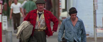 Movie still from “Scarecrow” (1973), directed by Jerry Schatzberg – Two men walking down the street wearing hats and jackets; Medium shot, Low angle