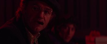 Movie still from “Scarecrow” (1973), directed by Jerry Schatzberg – A man in a hat and glasses smoking a cigarette; Close Up shot, Over the shoulder angle