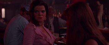Movie still from “Scarecrow” (1973), directed by Jerry Schatzberg – A woman in a pink shirt is sitting at a bar; Close Up shot, Over the shoulder angle