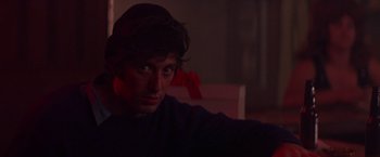 Movie still from “Scarecrow” (1973), directed by Jerry Schatzberg – A young man is sitting in a dark room; Close Up shot, Over the shoulder angle