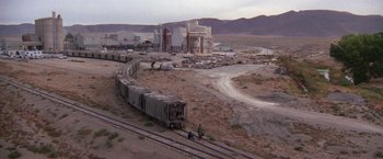 Movie still from “Scarecrow” (1973), directed by Jerry Schatzberg – A train is traveling down the tracks in the middle of the desert; Extreme Wide shot, High angle