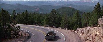 Movie still from “Scarecrow” (1973), directed by Jerry Schatzberg – An old pickup truck driving down a curvy road; Extreme Wide shot, High angle