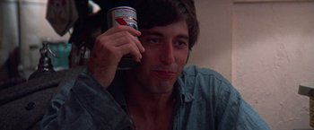Movie still from “Scarecrow” (1973), directed by Jerry Schatzberg – A man holding a can of beer up to his face; Close Up shot, Low angle