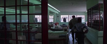 Movie still from “Scarecrow” (1973), directed by Jerry Schatzberg – A room filled with beds and a person standing in a room; Wide shot, High angle