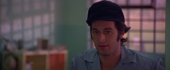 Movie still from “Scarecrow” (1973), directed by Jerry Schatzberg – A person wearing a hat; Close Up shot, Over the shoulder angle