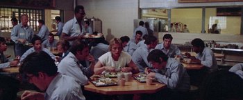 Movie still from “Scarecrow” (1973), directed by Jerry Schatzberg – A group of people sitting around a table eating; Wide shot, High angle