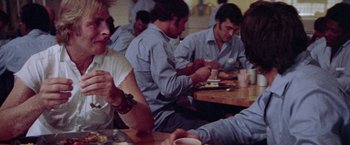 Movie still from “Scarecrow” (1973), directed by Jerry Schatzberg – A group of people sitting at a table eating food; Close Up shot, Over the shoulder angle