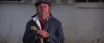 Movie still from “Scarecrow” (1973), directed by Jerry Schatzberg – An older man with glasses and a hat holding a cane; Medium shot, Low angle