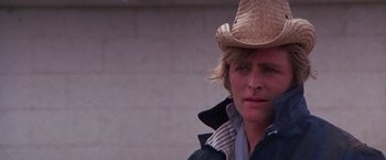 Movie still from “Scarecrow” (1973), directed by Jerry Schatzberg – A person wearing a straw hat; Close Up shot, Low angle