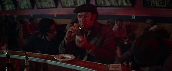 Movie still from “Scarecrow” (1973), directed by Jerry Schatzberg – An old man is eating pizza at a restaurant; Medium shot, Over the shoulder angle