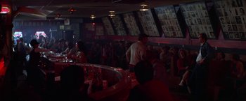 Movie still from “Scarecrow” (1973), directed by Jerry Schatzberg – A group of people are gathered around a bar; Wide shot, Over the shoulder angle