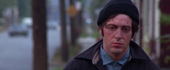 Movie still from “Scarecrow” (1973), directed by Jerry Schatzberg – A person wearing a jacket and a hat; Close Up shot, Low angle