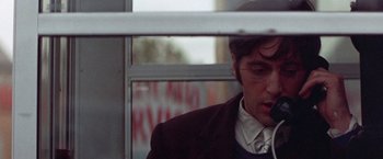 Movie still from “Scarecrow” (1973), directed by Jerry Schatzberg – A man in a suit and tie on a bus; Close Up shot, Low angle