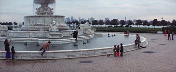 Movie still from “Scarecrow” (1973), directed by Jerry Schatzberg – A man is jumping in a fountain in a park; Extreme Wide shot, High angle