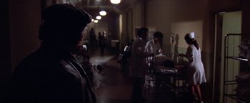 Movie still from “Scarecrow” (1973), directed by Jerry Schatzberg – A group of people standing in a room with tables; Wide shot, Over the shoulder angle