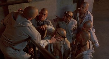 Movie still from “School Daze” (1988), directed by Spike Lee – A group of men standing next to each other in a room; Medium shot, High angle