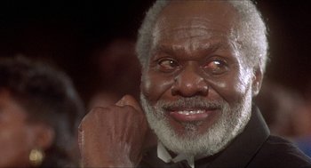 Movie still from “School Daze” (1988), directed by Spike Lee – An older man with grey hair and a white beard; Close Up shot, Low angle