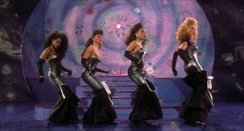 Movie still from “School Daze” (1988), directed by Spike Lee – A group of women dressed in black are performing a dance; Wide shot, High angle