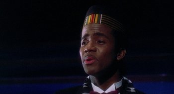 Movie still from “School Daze” (1988), directed by Spike Lee – A person wearing a hat; Close Up shot, Low angle