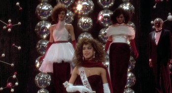Movie still from “School Daze” (1988), directed by Spike Lee – A group of women standing next to each other in dresses; Medium shot, Low angle