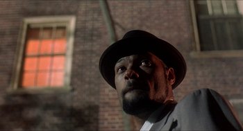 Movie still from “School Daze” (1988), directed by Spike Lee – A man wearing a suit and a hat looking up; Close Up shot, Low angle