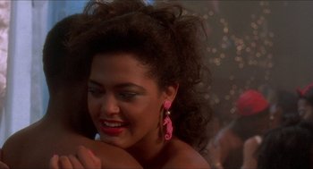 Movie still from “School Daze” (1988), directed by Spike Lee – A person hugging another person; Close Up shot, Over the shoulder angle