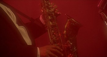Movie still from “School Daze” (1988), directed by Spike Lee – A man holding a saxophone in his hands; Close Up shot, Low angle