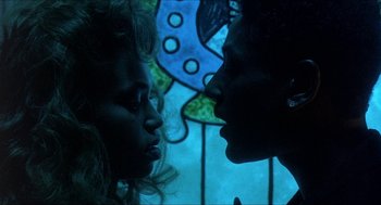 Movie still from “School Daze” (1988), directed by Spike Lee – Two women face each other in front of a stained glass window; Close Up shot, Low angle