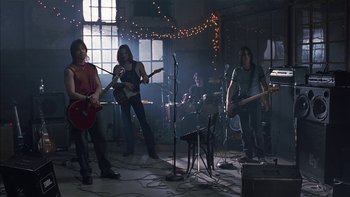 Movie still from “School of Rock” (2003), directed by Richard Linklater – A group of young people playing instruments in a room; Wide shot, Low angle