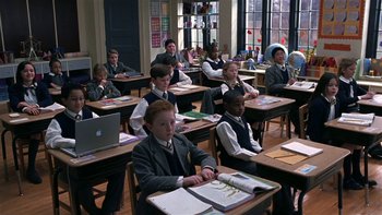Movie still from “School of Rock” (2003), directed by Richard Linklater – A group of young people sitting at desks in a class room; Wide shot, High angle