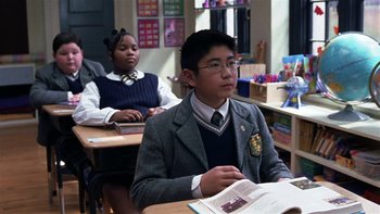 Movie still from “School of Rock” (2003), directed by Richard Linklater – A boy and girl sitting at a table in a classroom; Medium shot, High angle