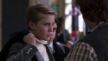 Movie still from “School of Rock” (2003), directed by Richard Linklater – A young boy adjusting a tie on a young man; Close Up shot, Low angle
