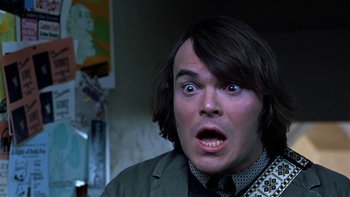 Movie still from “School of Rock” (2003), directed by Richard Linklater – A person wearing a suit and tie; Close Up shot, Low angle