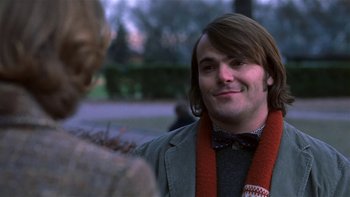 Movie still from “School of Rock” (2003), directed by Richard Linklater – A man with long brown hair wearing a bow tie; Close Up shot, Over the shoulder angle