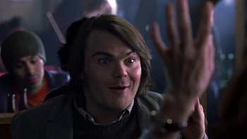 Movie still from “School of Rock” (2003), directed by Richard Linklater – A person with long brown hair; Close Up shot, Low angle