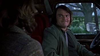 Movie still from “School of Rock” (2003), directed by Richard Linklater – A man sitting in the back seat of a car; Close Up shot, Over the shoulder angle