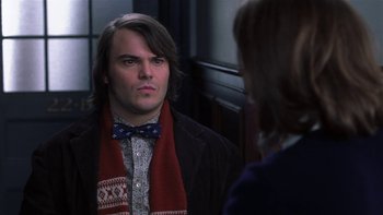 Movie still from “School of Rock” (2003), directed by Richard Linklater – A man wearing a bow tie looking at a woman in the mirror; Close Up shot, Over the shoulder angle