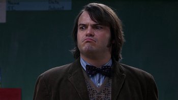 Movie still from “School of Rock” (2003), directed by Richard Linklater – A person wearing a jacket and a bow tie; Close Up shot, Low angle