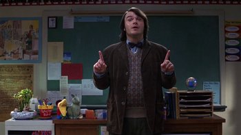 Movie still from “School of Rock” (2003), directed by Richard Linklater – A man standing in front of a chalkboard pointing up; Medium shot, Over the shoulder angle