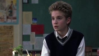 Movie still from “School of Rock” (2003), directed by Richard Linklater – A young boy in a school uniform sitting in front of a chalkboard; Close Up shot, Low angle