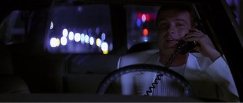 Movie still from “Scream 3” (2000), directed by Wes Craven – A man sitting in the driver's seat of a car at night; Close Up shot, Low angle