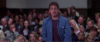 Movie still from “Scream 3” (2000), directed by Wes Craven – A man standing in front of a crowd of people; Medium shot, Low angle