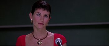 Movie still from “Scream 3” (2000), directed by Wes Craven – A person with a microphone in a room; Close Up shot, Over the shoulder angle